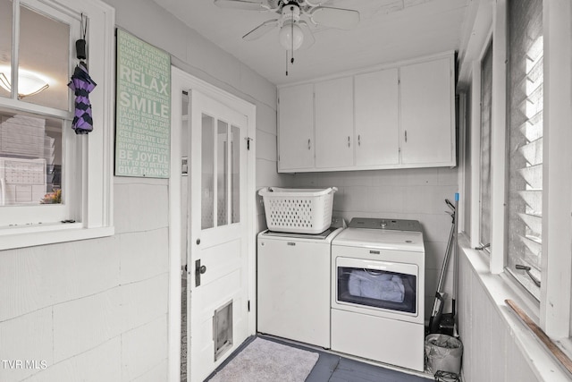 clothes washing area featuring cabinets, ceiling fan, and separate washer and dryer