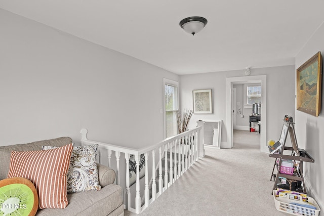 hallway featuring carpet floors and plenty of natural light