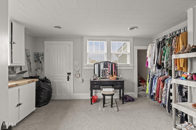 spacious closet featuring light carpet