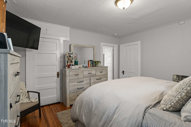 bedroom with dark hardwood / wood-style floors