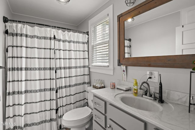 bathroom featuring oversized vanity, ornamental molding, and toilet