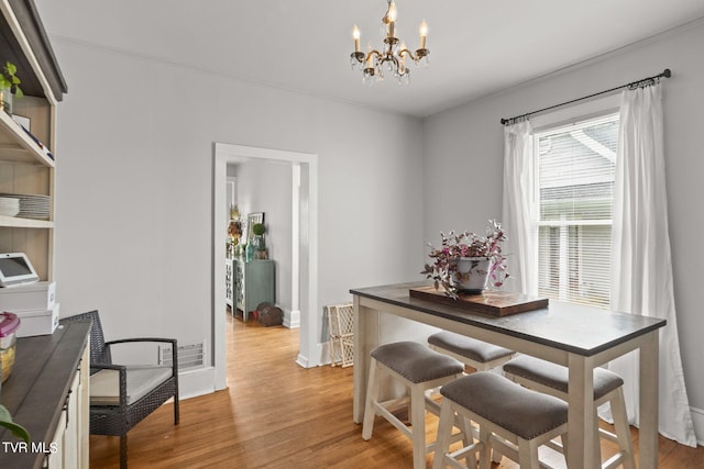 dining space with an inviting chandelier and light wood-type flooring