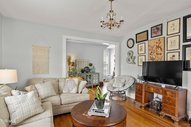 living room with a notable chandelier and wood-type flooring