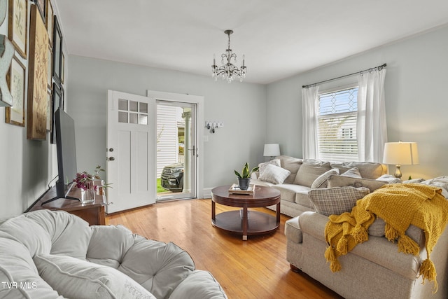 living room with a chandelier and light hardwood / wood-style flooring