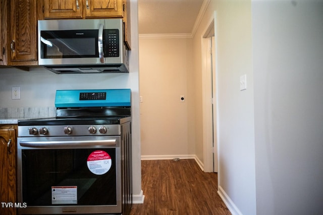 1466 Broad St, Elizabethton, TN 37643 - kitchen with brown cabinets, ornamental molding, dark wood finished floors, stainless steel appliances, and baseboards