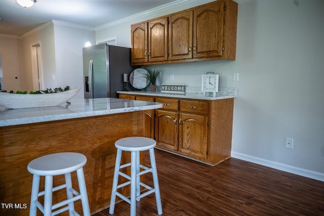 1466 Broad St, Elizabethton, TN 37643 - kitchen with brown cabinets, ornamental molding, stainless steel refrigerator with ice dispenser, dark wood finished floors, and a breakfast bar area