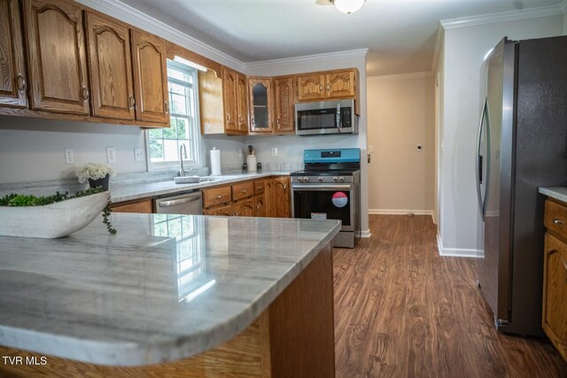 1466 Broad St, Elizabethton, TN 37643 - kitchen with ornamental molding, a sink, appliances with stainless steel finishes, brown cabinetry, and dark wood-style flooring