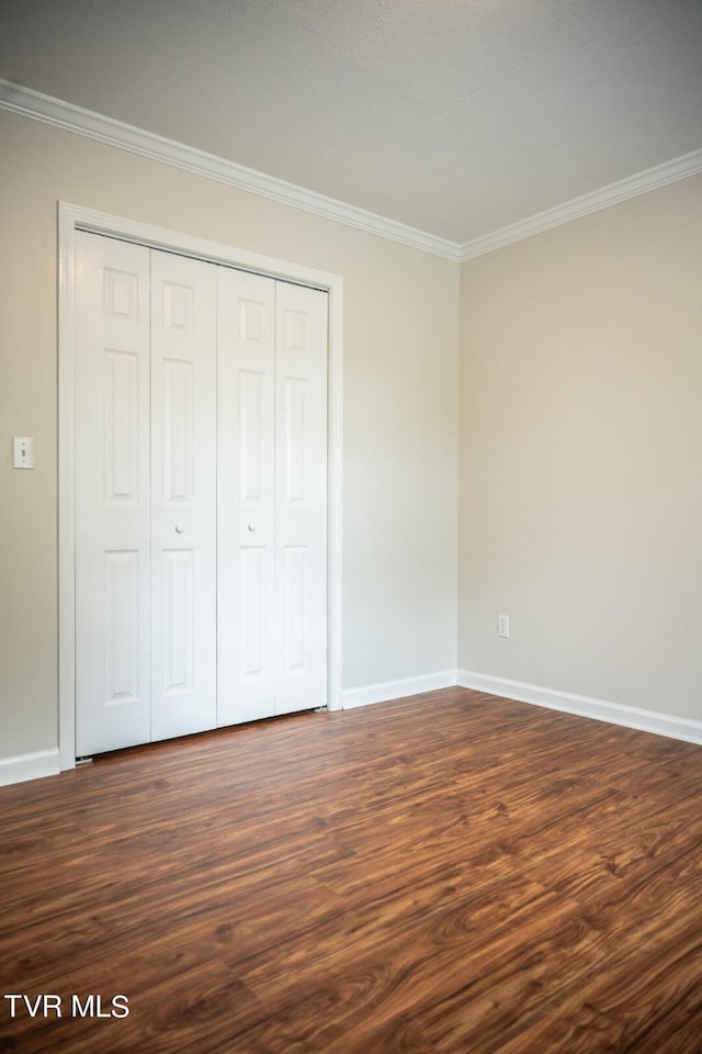 1466 Broad St, Elizabethton, TN 37643 - unfurnished bedroom featuring crown molding, baseboards, and dark wood-style flooring