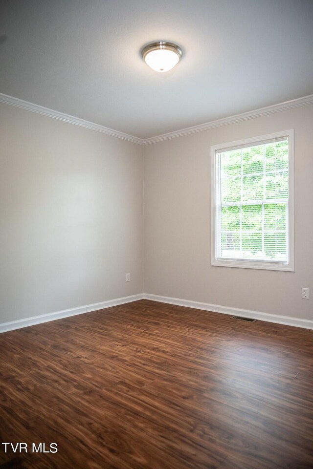 1466 Broad St, Elizabethton, TN 37643 - unfurnished room featuring dark wood-style floors, crown molding, and baseboards