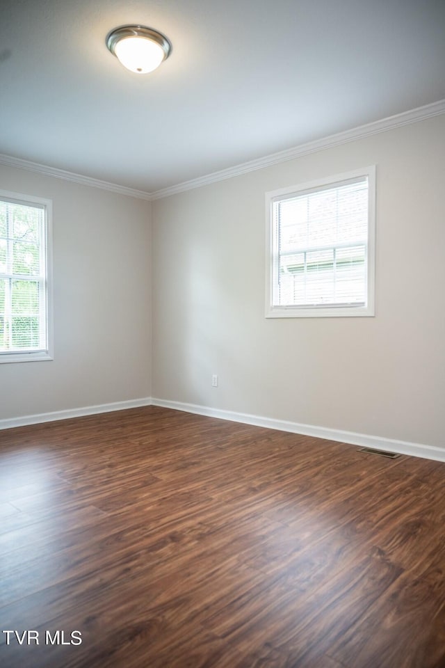 1466 Broad St, Elizabethton, TN 37643 - empty room with dark wood-style floors, visible vents, baseboards, and ornamental molding