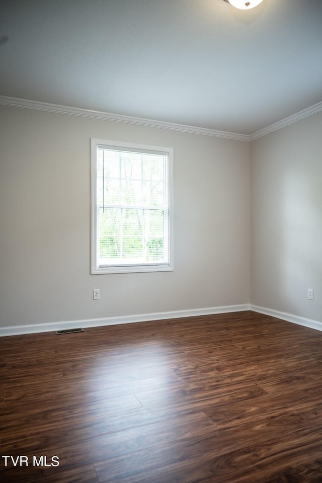 1466 Broad St, Elizabethton, TN 37643 - spare room featuring dark wood finished floors, visible vents, baseboards, and ornamental molding