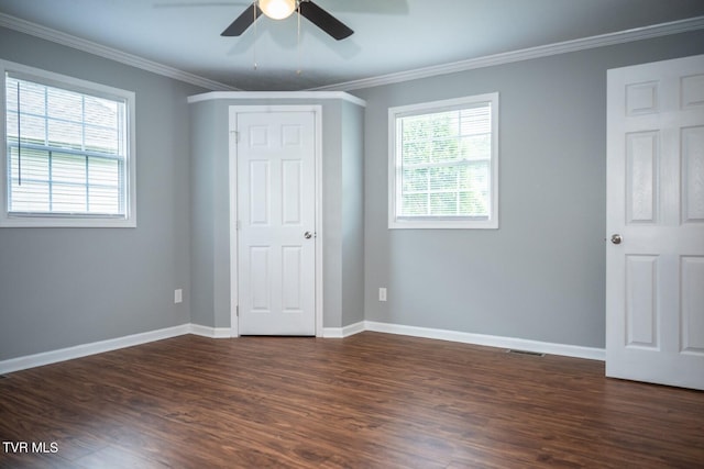1466 Broad St, Elizabethton, TN 37643 - unfurnished bedroom featuring crown molding, multiple windows, and dark wood-type flooring