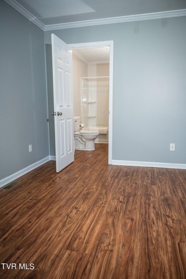 1466 Broad St, Elizabethton, TN 37643 - unfurnished bedroom with visible vents, baseboards, dark wood finished floors, ornamental molding, and ensuite bathroom