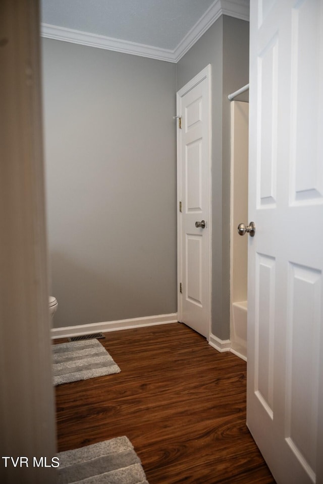 1466 Broad St, Elizabethton, TN 37643 - hallway with dark wood finished floors, visible vents, baseboards, and ornamental molding