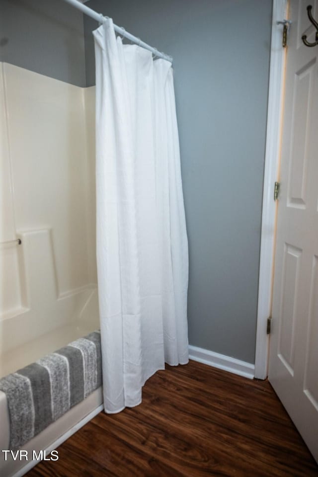 1466 Broad St, Elizabethton, TN 37643 - full bath with shower / tub combo, wood finished floors, and baseboards