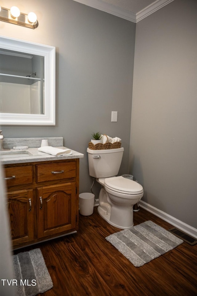 1466 Broad St, Elizabethton, TN 37643 - bathroom featuring vanity, wood finished floors, baseboards, ornamental molding, and toilet