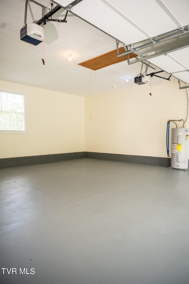 1466 Broad St, Elizabethton, TN 37643 - garage featuring baseboards, electric water heater, and a garage door opener