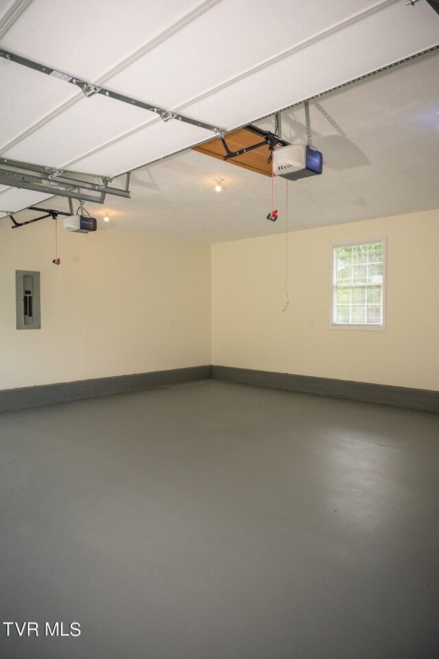 1466 Broad St, Elizabethton, TN 37643 - garage featuring electric panel, a garage door opener, and baseboards