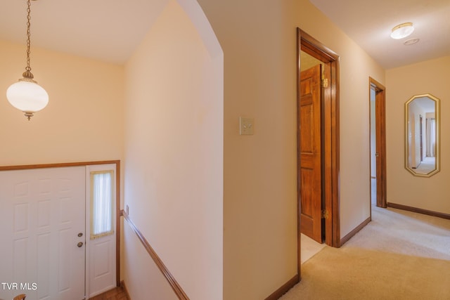 foyer entrance with light colored carpet