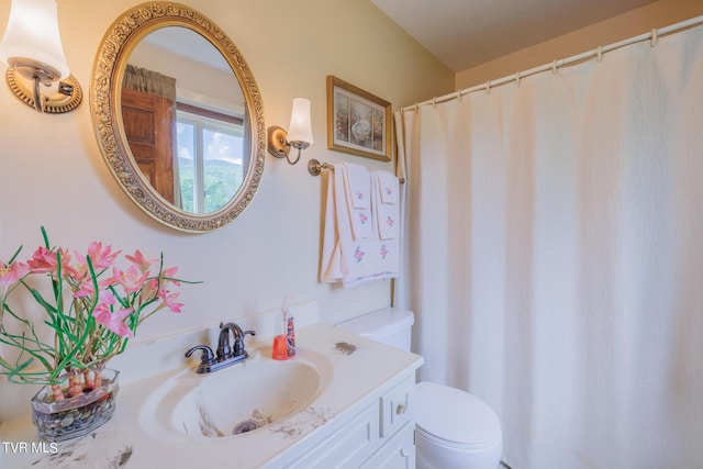 bathroom featuring vanity and toilet