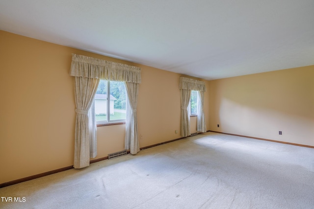 empty room featuring light carpet and a wealth of natural light