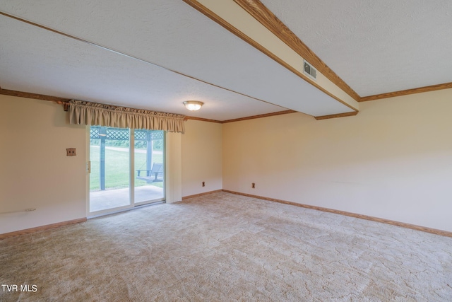 carpeted empty room featuring ornamental molding and a textured ceiling