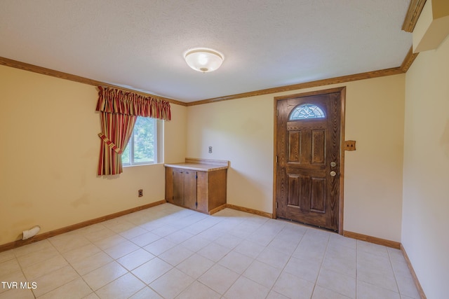 foyer featuring ornamental molding and a textured ceiling