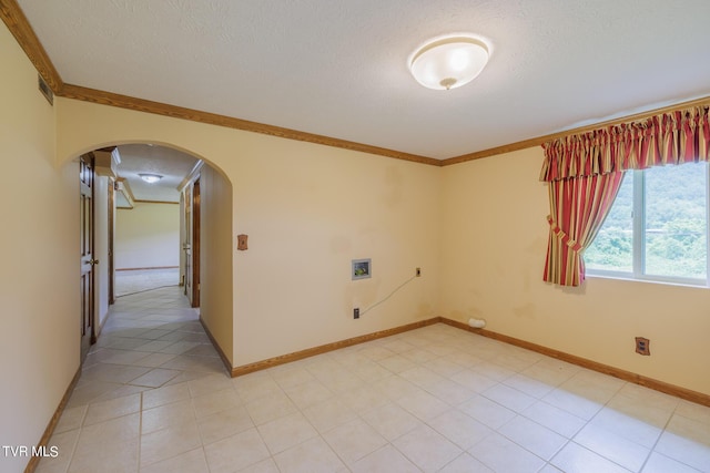 empty room featuring ornamental molding and a textured ceiling