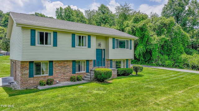 bi-level home with a front lawn