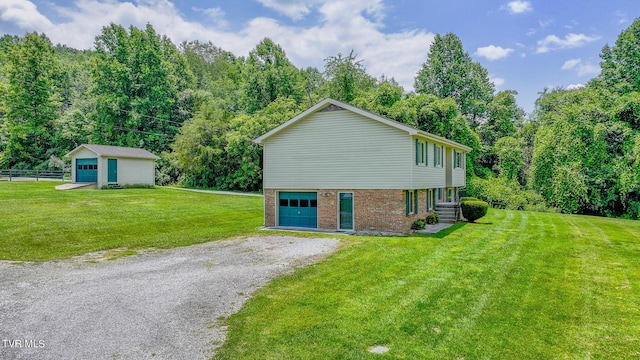 view of side of home with a garage, an outdoor structure, and a lawn