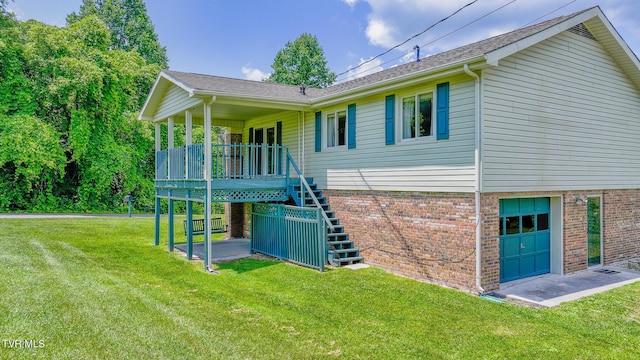 back of house with a yard, a garage, and covered porch