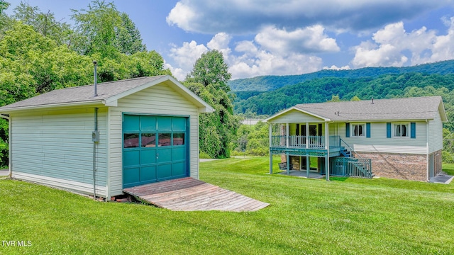 garage featuring a mountain view and a lawn