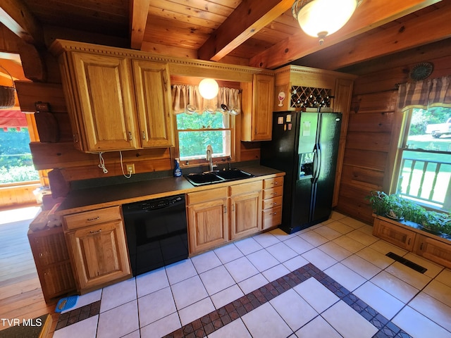 kitchen featuring sink, light tile patterned floors, black appliances, and a healthy amount of sunlight