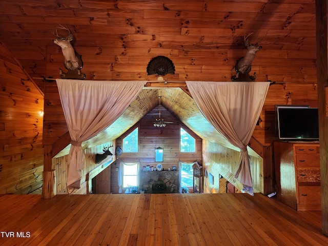 interior space with lofted ceiling and wood walls