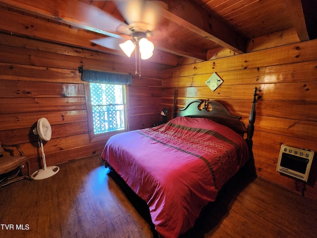 bedroom featuring heating unit, beamed ceiling, ceiling fan, dark wood-type flooring, and wooden ceiling