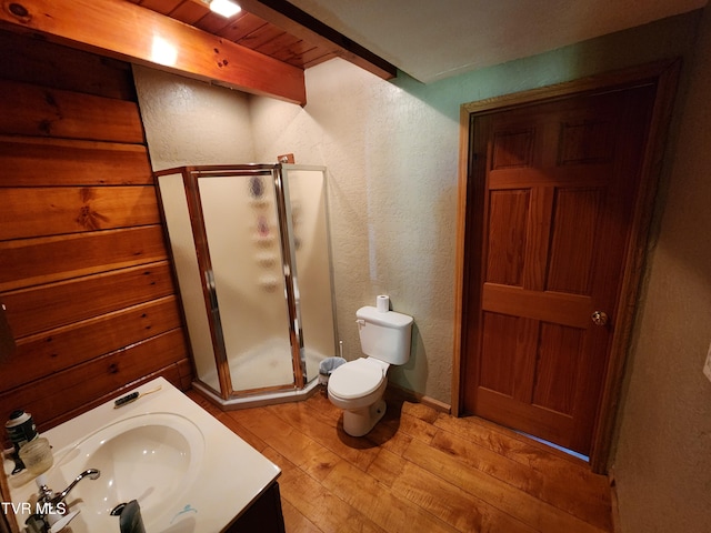 bathroom featuring wood ceiling, hardwood / wood-style floors, beam ceiling, toilet, and walk in shower