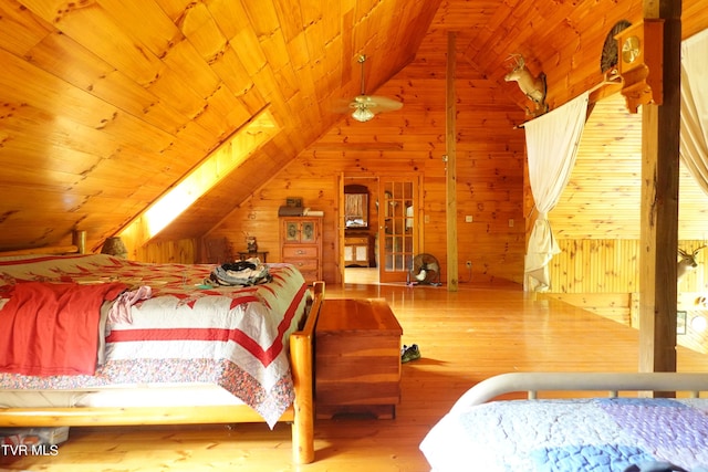 bedroom with lofted ceiling, wood-type flooring, wooden walls, and wooden ceiling