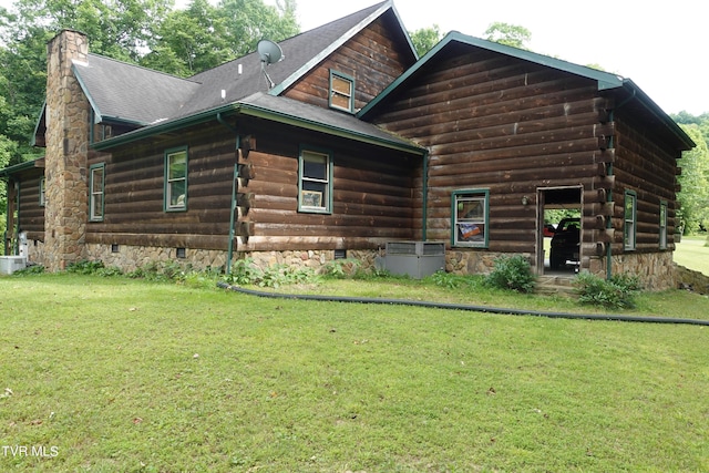 rear view of property featuring a yard