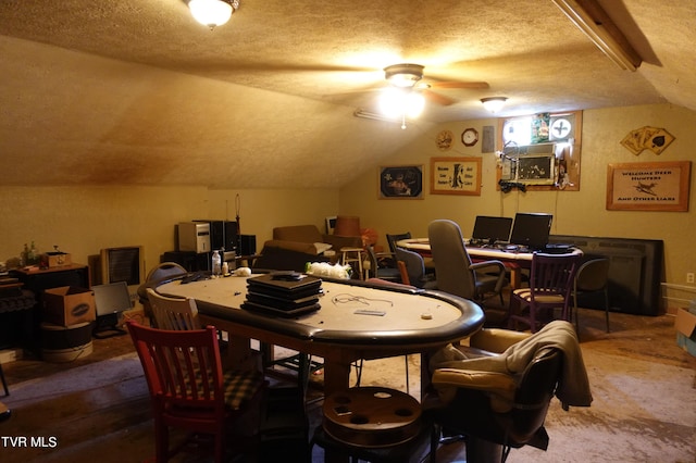 dining area featuring ceiling fan, lofted ceiling, and a textured ceiling