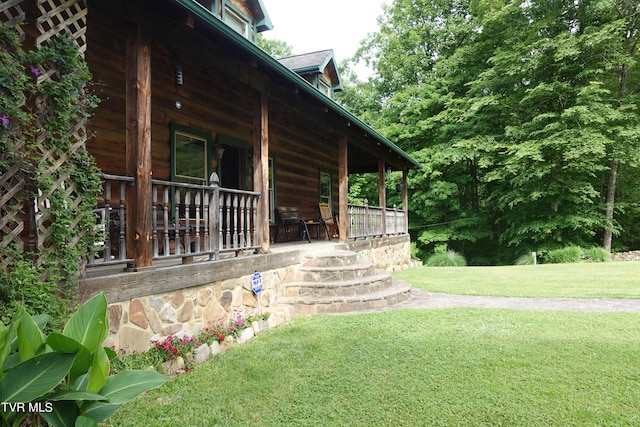 view of property exterior with a yard and a porch