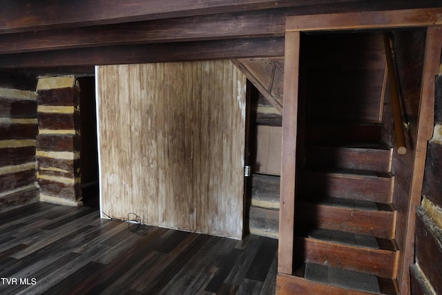 stairway with wooden walls and wood-type flooring