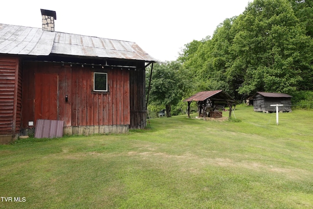 view of outdoor structure featuring a lawn