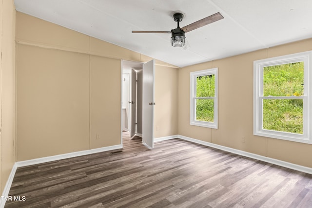 unfurnished room with ceiling fan, vaulted ceiling, and hardwood / wood-style floors