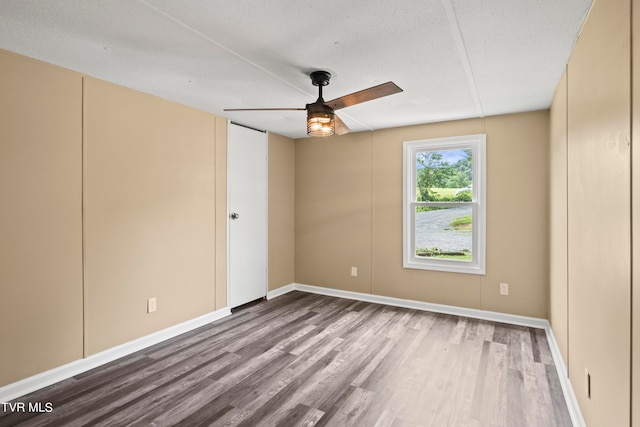 unfurnished room featuring hardwood / wood-style flooring, ceiling fan, and a textured ceiling