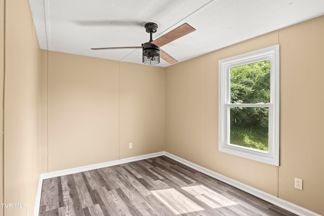 spare room with wood-type flooring and ceiling fan