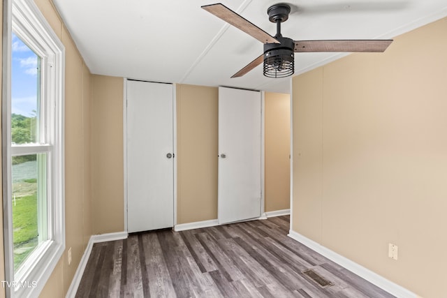 unfurnished bedroom with ceiling fan and hardwood / wood-style floors