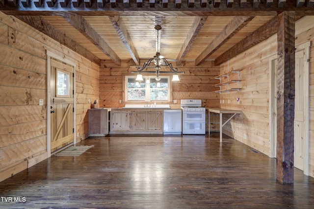 interior space with a wealth of natural light, wooden walls, and dark hardwood / wood-style flooring