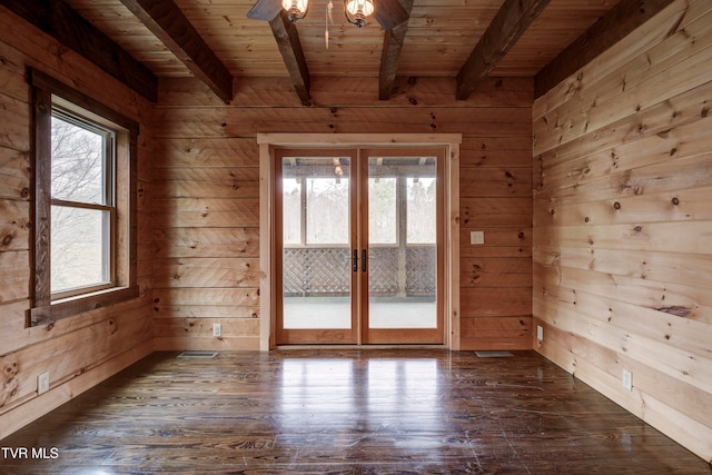 unfurnished room featuring french doors, dark hardwood / wood-style floors, and wooden walls