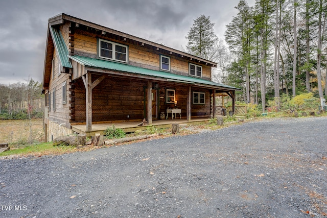 log home featuring a porch