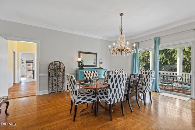 dining space featuring ornamental molding and an inviting chandelier